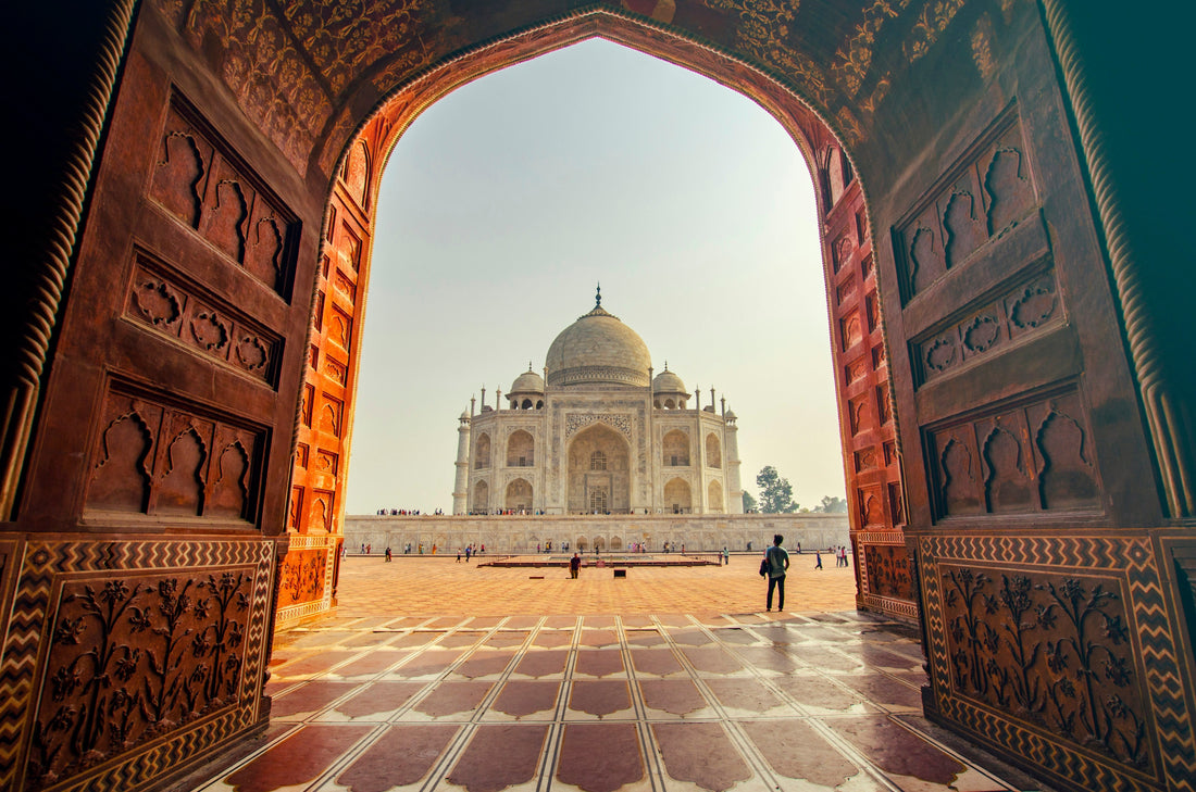Carved sandstone jaali lattice screen with light passing through geometric openings