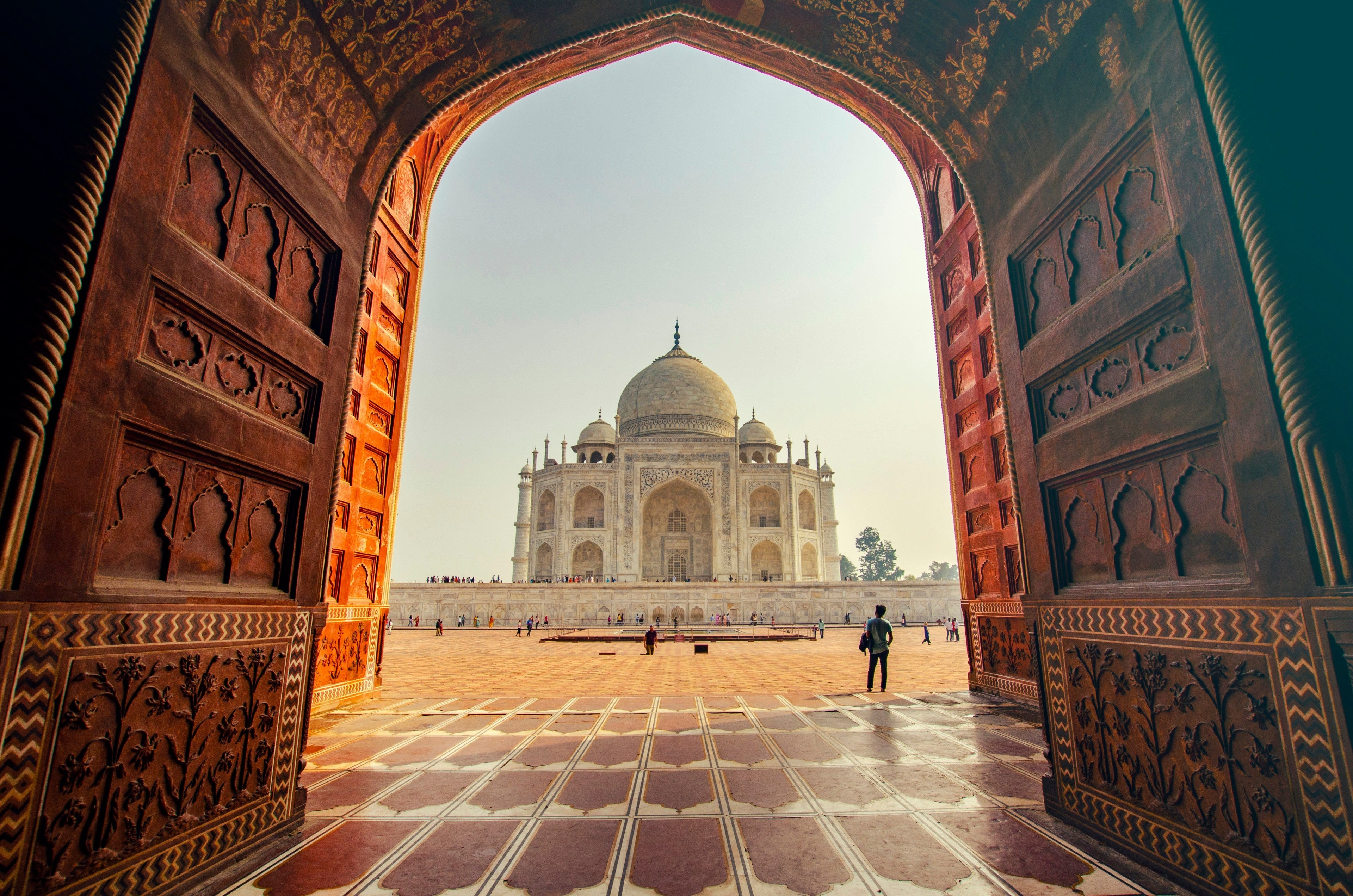 Carved sandstone jaali lattice screen with light passing through geometric openings