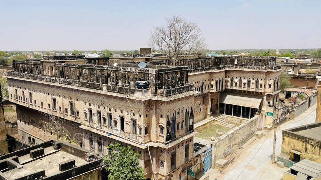 Traditional Rajasthani haveli facade with layered courtyard windows and balconies